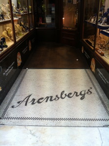 The doorway of Arensberg's, showing the gold-leaf painted lettering and the tiled floor mosaic.
